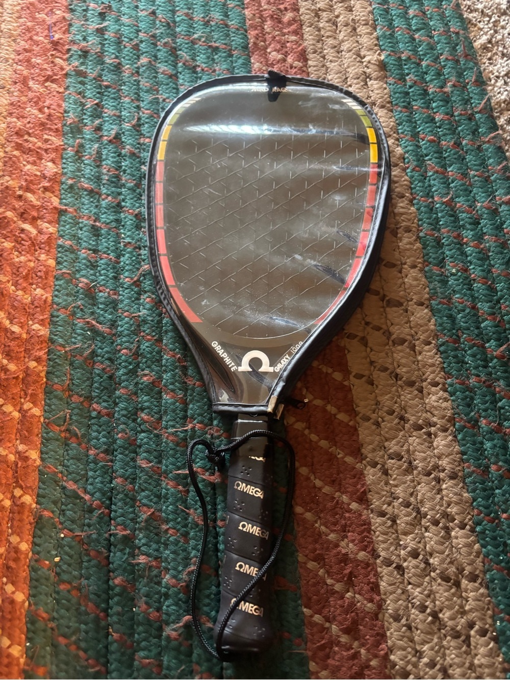 Omega Black Racketball Racket with Red and Yellow Accents